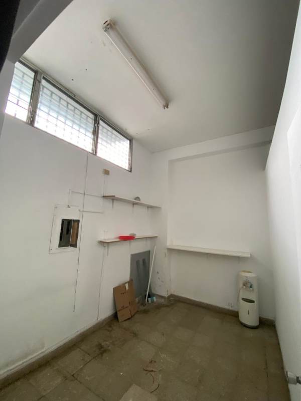 Unfinished utility or storage space with glass block ventilation windows inside retail space Panama