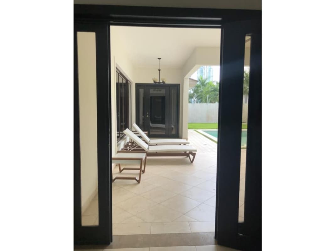 Luxury living room with large windows and garden view Paseo del Parque Panama