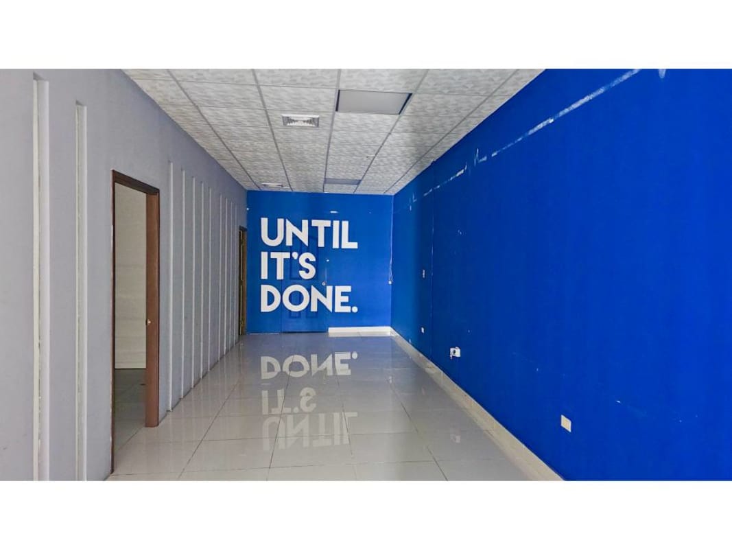 Open Hallway with blue accent wall motivational quotes tiled floor at Display Plaza Panama City