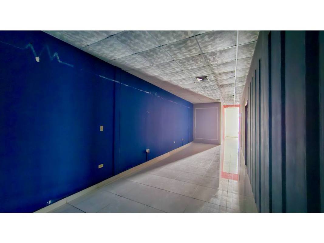 Modern commercial hallway interior with blue wall and tiled floor in Display Plaza Panama City