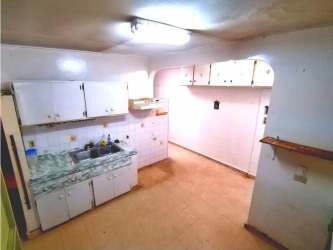 Kitchen area with white cabinets, marble-look countertop and tile backsplash in San Antonio house