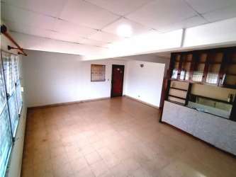 Spacious living area with ceramic tiles, built-in shelving, large windows and ceiling tiles in San Antonio house
