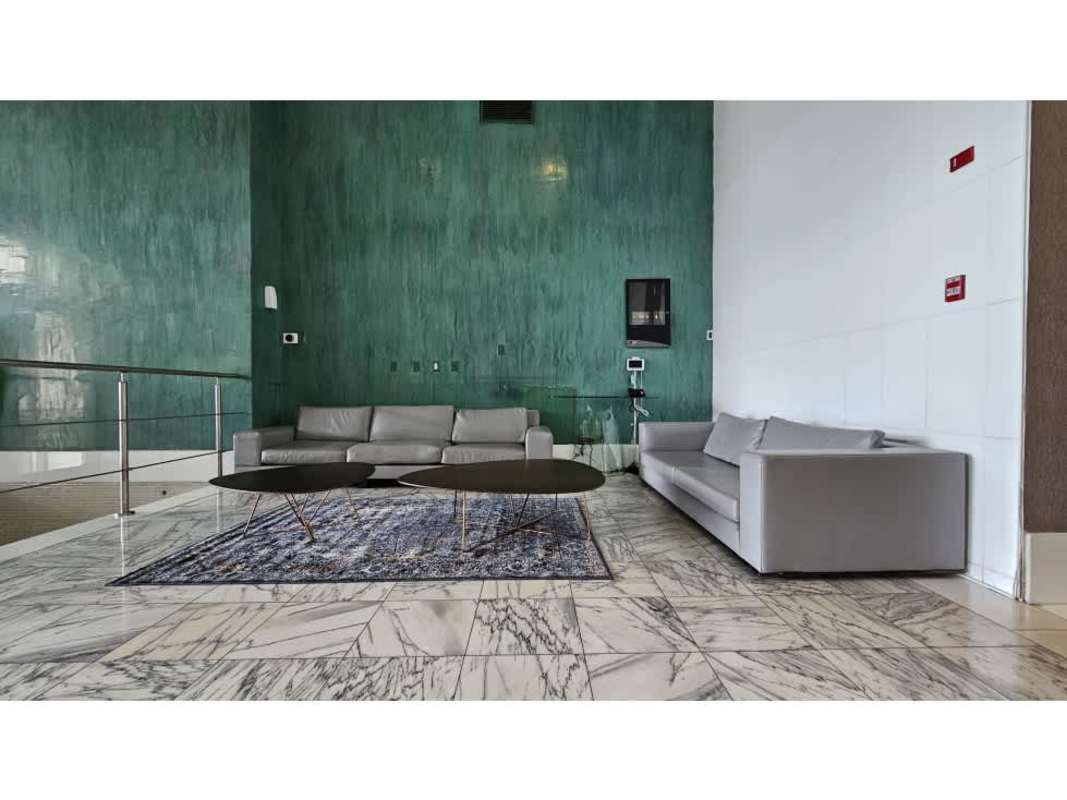 Living room with sliding glass doors to balcony overlooking ocean Waters on the Bay Panama