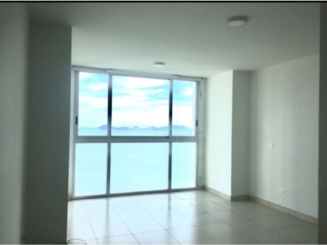 Bright empty living room with floor-to-ceiling glass windows ocean view Panama Waters on the Bay