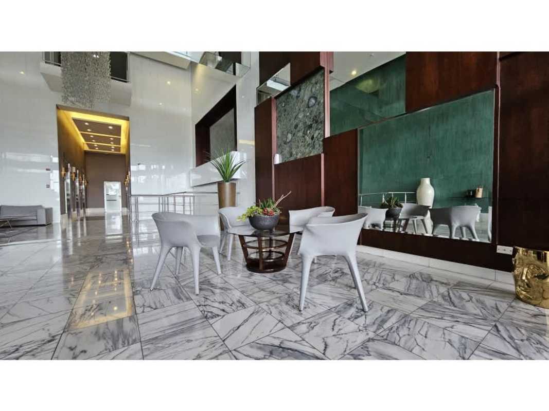 Marble wall lobby with wicker chairs and glass doors Waters on the Bay Panama