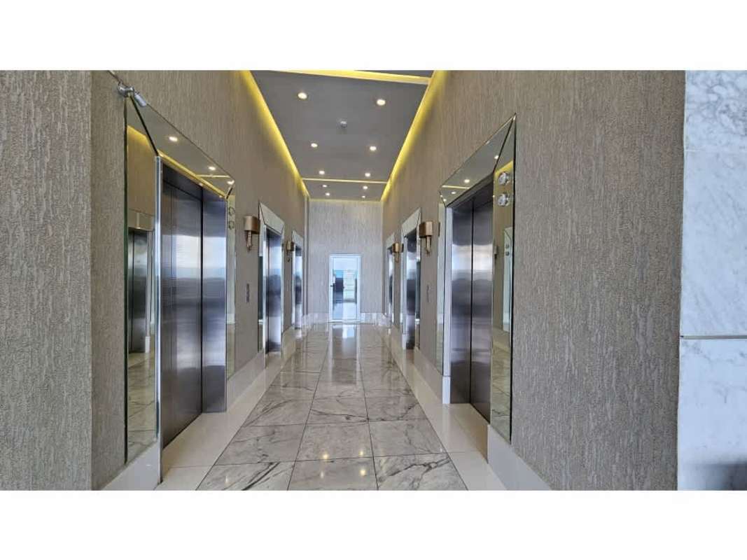 Marble floor elevator lobby with stainless steel elevators Waters on the Bay Panama City