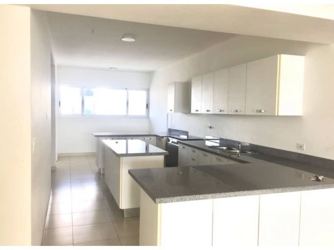 Bright modern kitchen with granite counters, island peninsula and large windows PH Waters Panama City