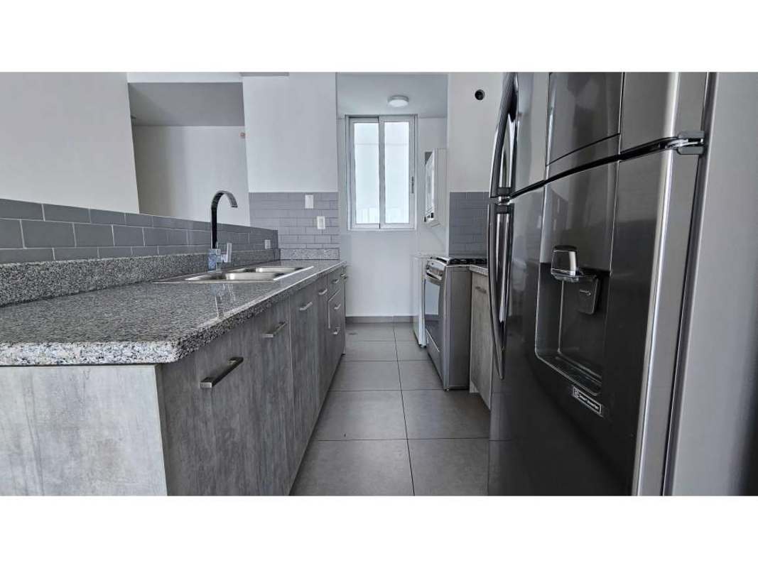 Rooftop infinity edge swimming pool with glass railings overlooking the city and bay in PH Signature Point Panama City