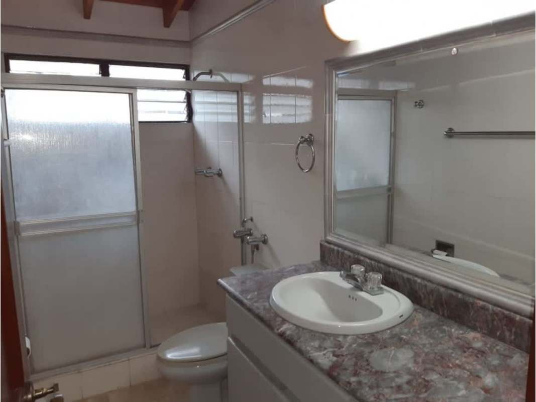 Bathroom with pedestal sink, ornate framed mirror and tiled walls Betania Panama