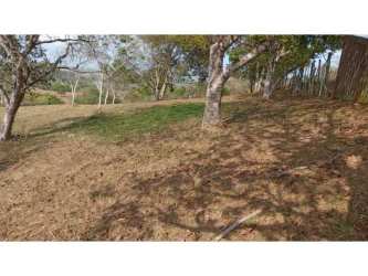 Rustic red wooden gate of fenced 10,000m² corner lot Potrero Grande La Chorrera Panama Oeste