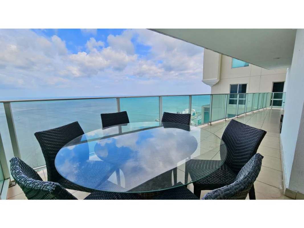 Oceanfront balcony dining space with table and skyline view Punta Pacifica Panama