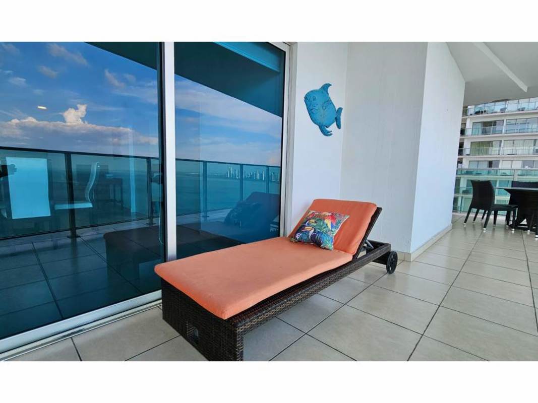 Furnished main bedroom with large windows and private balcony access in PH Oasis on the Bay