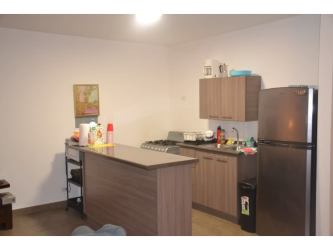 Kitchen with tile counters, wood cabinets, stove and refrigerator PH Maja Coclé Panama