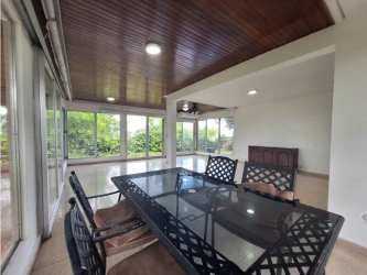Dining space with panoramic windows overlooking lush greenery El Dorado house for rent