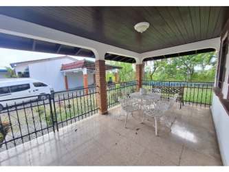 Front terrace with garden, brick columns, outdoor seating in El Dorado Panama house rental