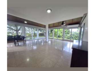 Living room with large windows, garden views in El Dorado Panama family house