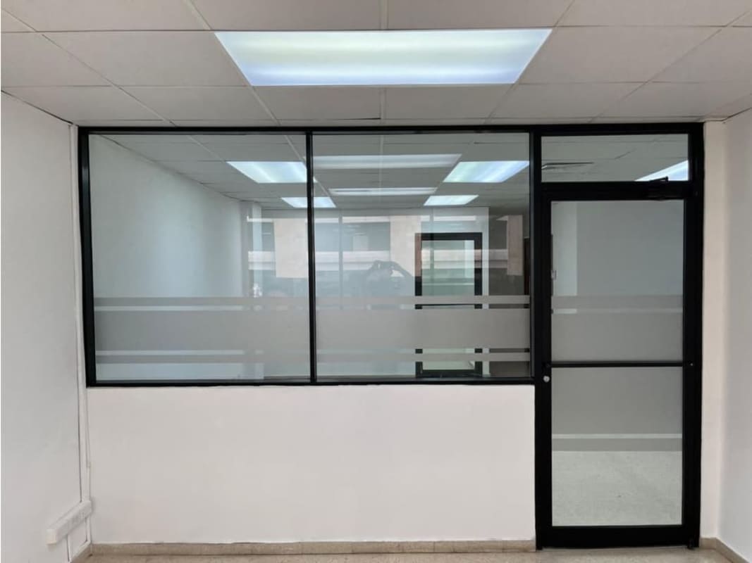 Office interior with drop ceiling glass door partition ceramic tile at PH Galerías Balboa
