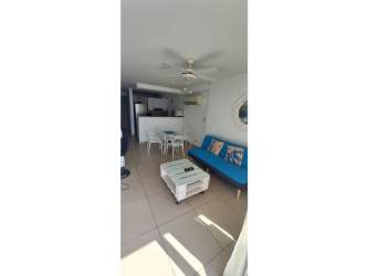 Compact kitchen with microwave and glass table dining next to oceanfront window at PH El Palmar San Carlos Panama