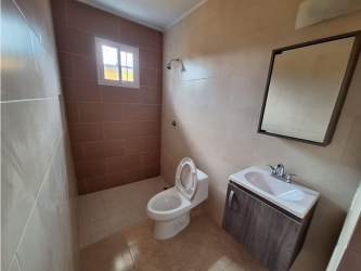 Modern tiled bathroom with sink toilet shower new house Santa Clara Panama