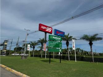 Commercial shopping center entrance near Playa Blanca beach including supermarkets and stores