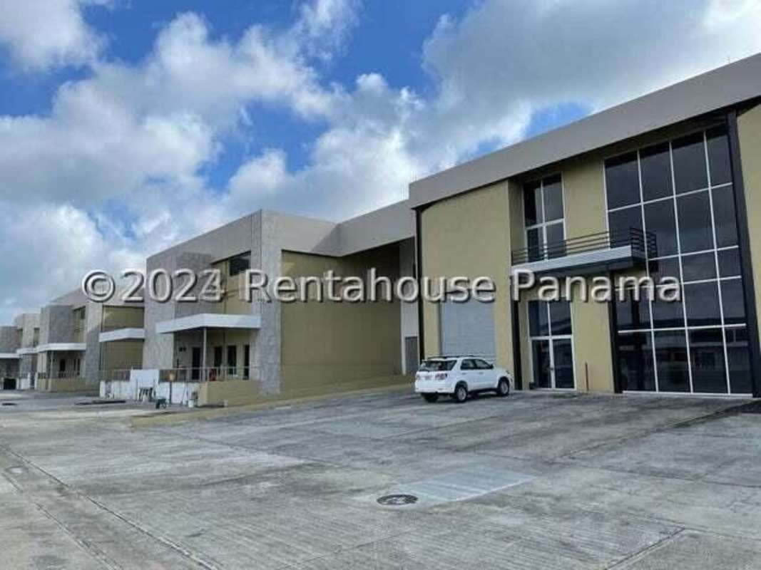 Large industrial complex exterior with paved driveway and parking at Pacora Panama