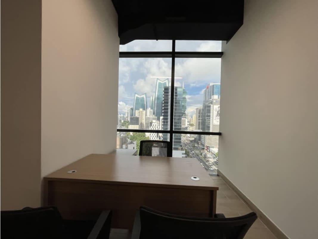 Private executive office with large window Panama skyline Tower Financial Center