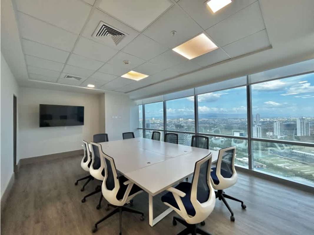 Modern conference room with large table, panoramic windows, city skyline view at Financial Park Costa del Este