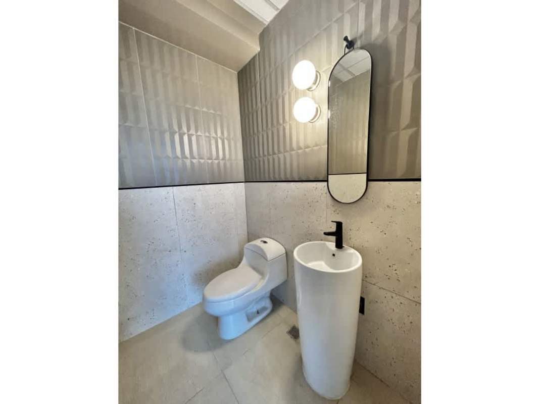 Modern kitchenette for staff with fridge and cabinets in furnished office Financial Park Panama