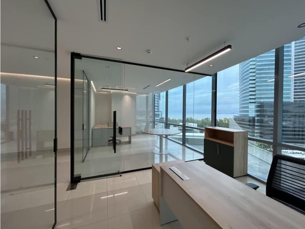 Glass-partitioned private offices with ocean and city views for lease in Costa del Este