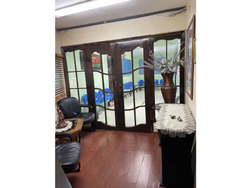 Waiting space with black leather chairs glass French doors commercial office Betania Panama