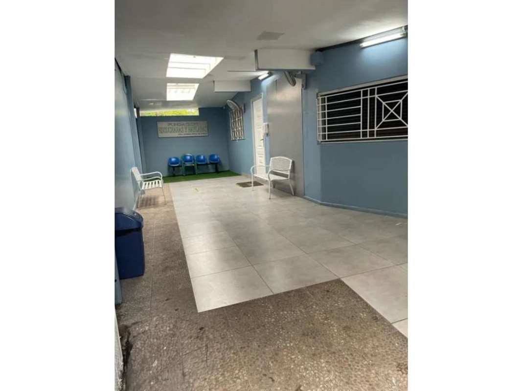 Covered hallway with skylights blue painted walls seating Panama office