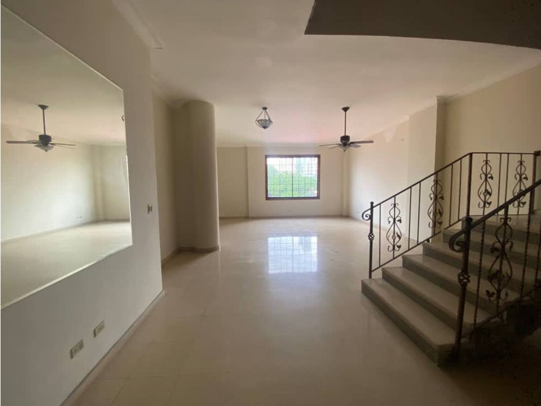Large living room with stone wall accent and ceiling fans in PH Ariadne San Francisco Panama