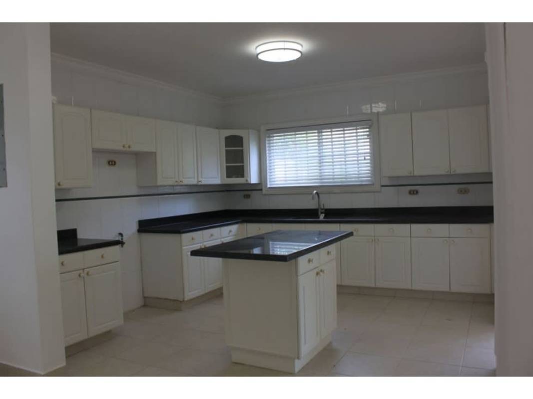 Spacious kitchen with island, granite countertops and appliances in Costa del Este house Panama