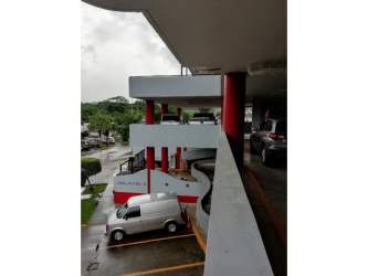 Cubicle spaces with desks chairs overhead cabinets PH Milano Office Panama