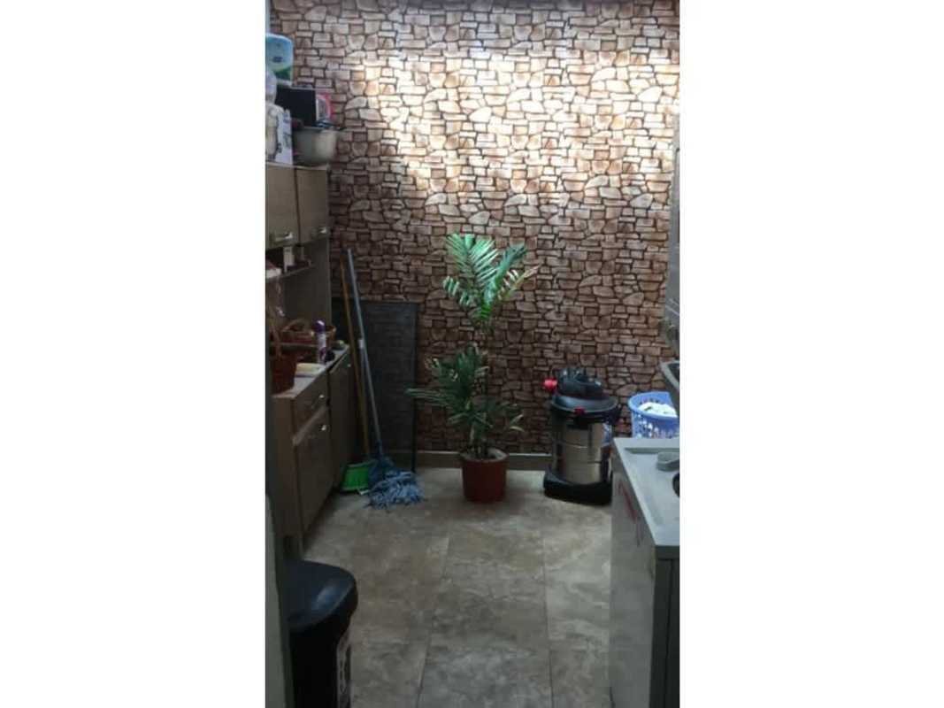 Utility room with cabinets, stone accent wall, cleaning supplies in Brisas del Golf Panama