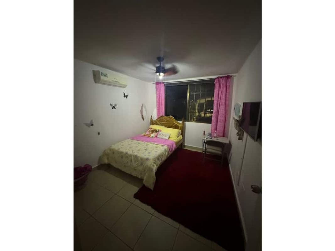 Cozy bedroom featuring AC, fan, window with pink curtains in Brisas del Golf Panama