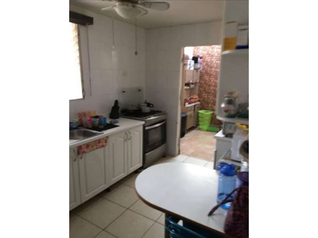 Traditional living room with arched windows, chandelier, red walls in Brisas del Golf Panama
