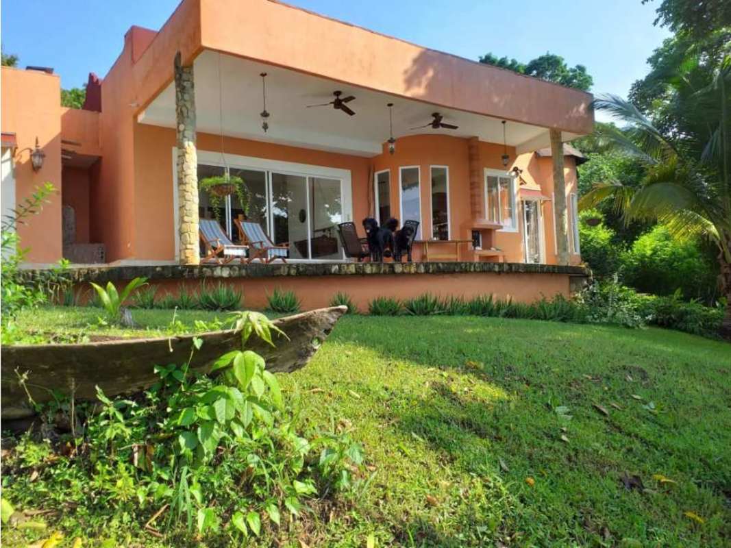 Mediterranean style porch with ocean view beside palm trees at Las Perlas Island Panama