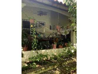 Secure gated driveway entrance with security booth and greenery at Chitré estate Panama