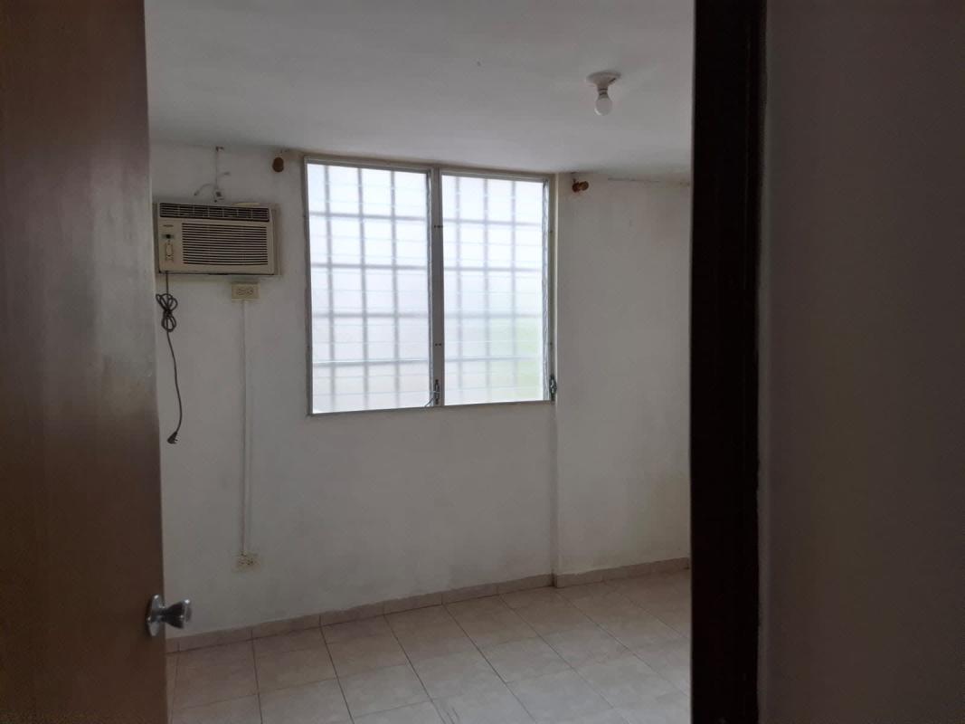 Compact kitchen in Panama apartment with tile countertop, sink, window and AC unit PH Cantabria