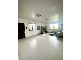 Dining room with high ceiling, teal accent wall and ceiling fan in Llano Hermoso house