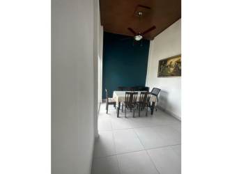 Outdoor patio area and fenced backyard with green lawn in Llano Hermoso Penonomé