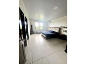 Spacious bedroom with tiled floors and garden view in Llano Hermoso Penonomé