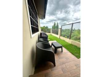Bathroom featuring glass shower, vessel sink and dark vanity in Penonomé