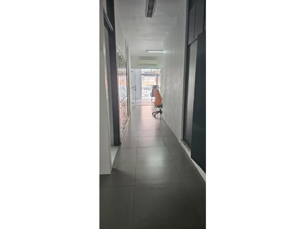 Narrow hallway with tiled floors, lockers, and glass door PH 46B Panama