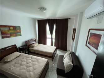 Guest bedroom with two beds, AC, dark curtains, balcony at Playa Blanca Resort beach condo Panama