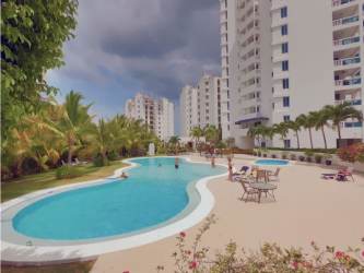 Balcony with ocean and pool views, glass railing, BBQ grill at Playa Blanca Beach Resort Panama