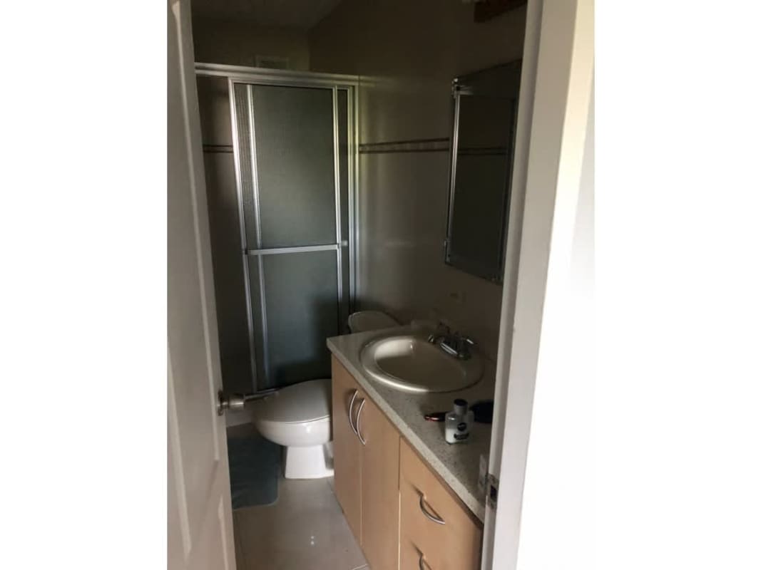 Bathroom in PH Aranjuez apartment with tiled walls, vanity and glass shower enclosure in El Cangrejo Panama