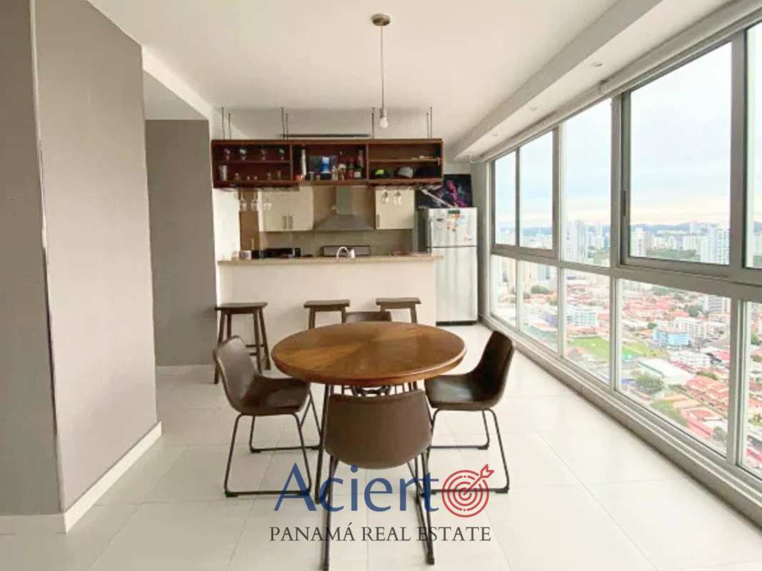 Modern open plan loft living and dining space with large windows at PH Coco del Mar Panama
