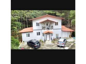 Family lounge space upstairs opening to balcony overlooking forest Cerro Azul